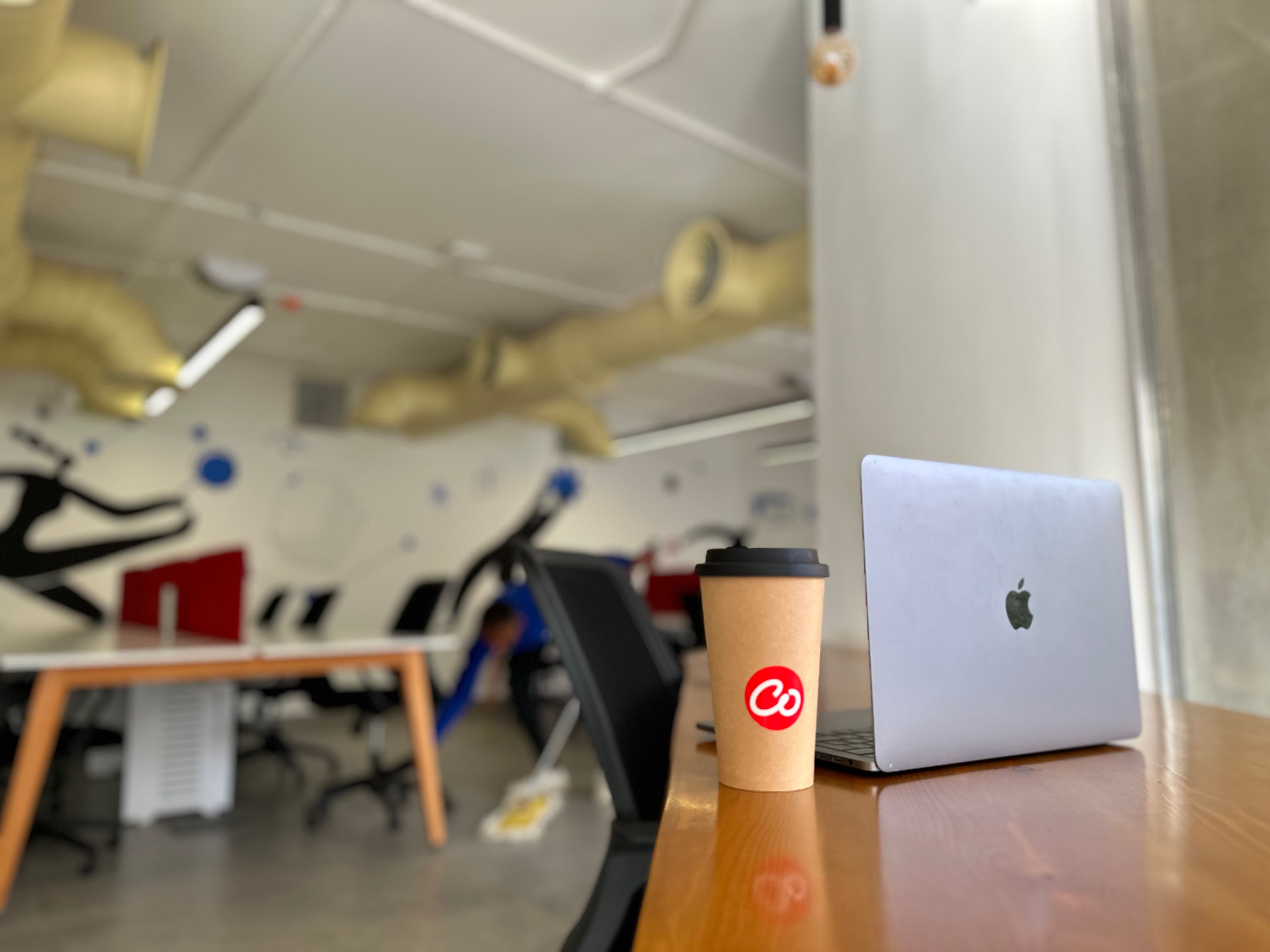 Coffee and a laptop shown in our coworking space, Coworker. 
